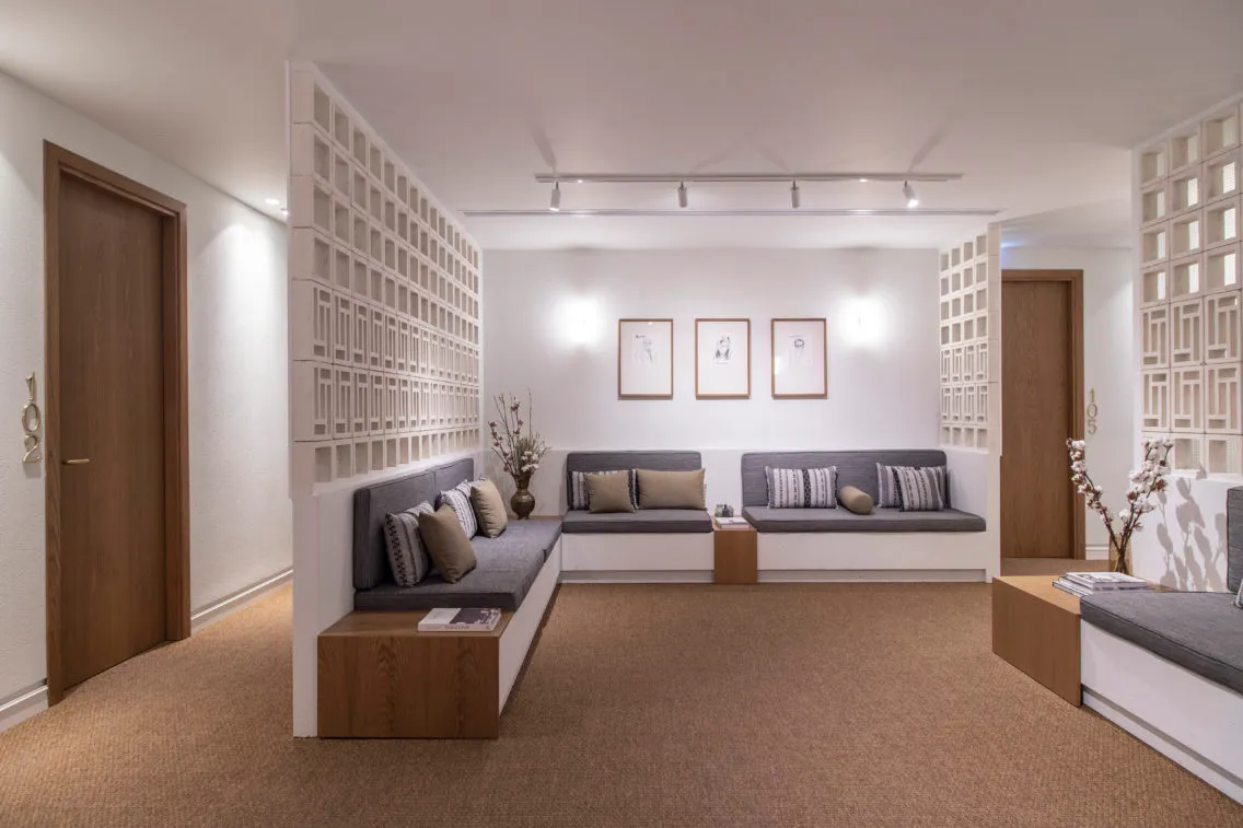 A living room with modern furniture, neutral color palette, and minimalist decor.