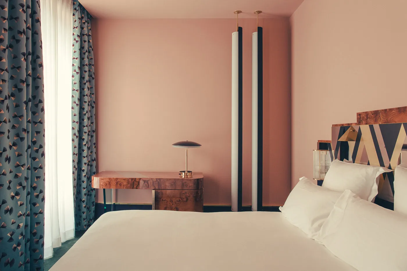 Bedroom with minimalist design, featuring a wooden bed frame and white bedding.