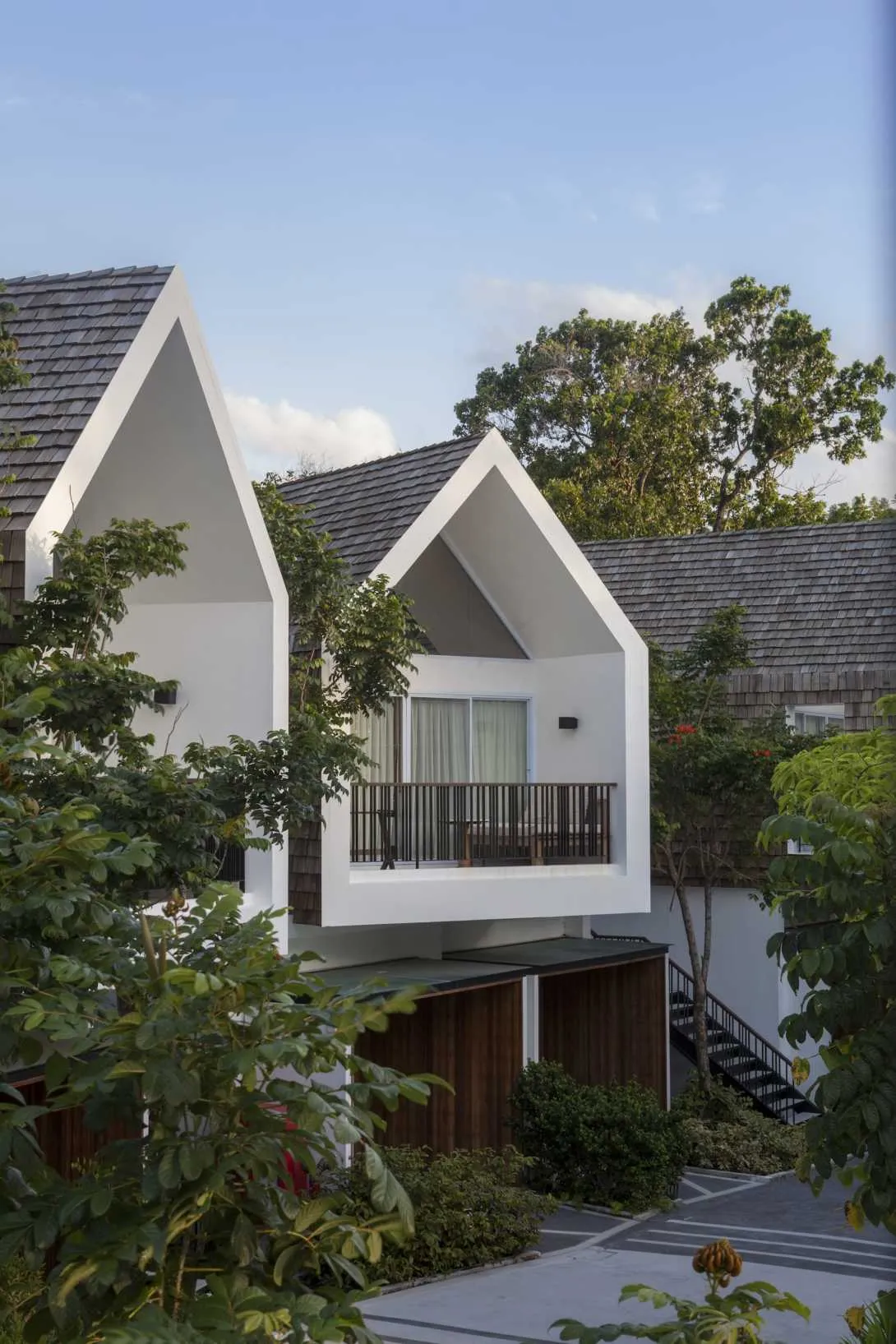 Modern residential home with white stucco exterior and grass