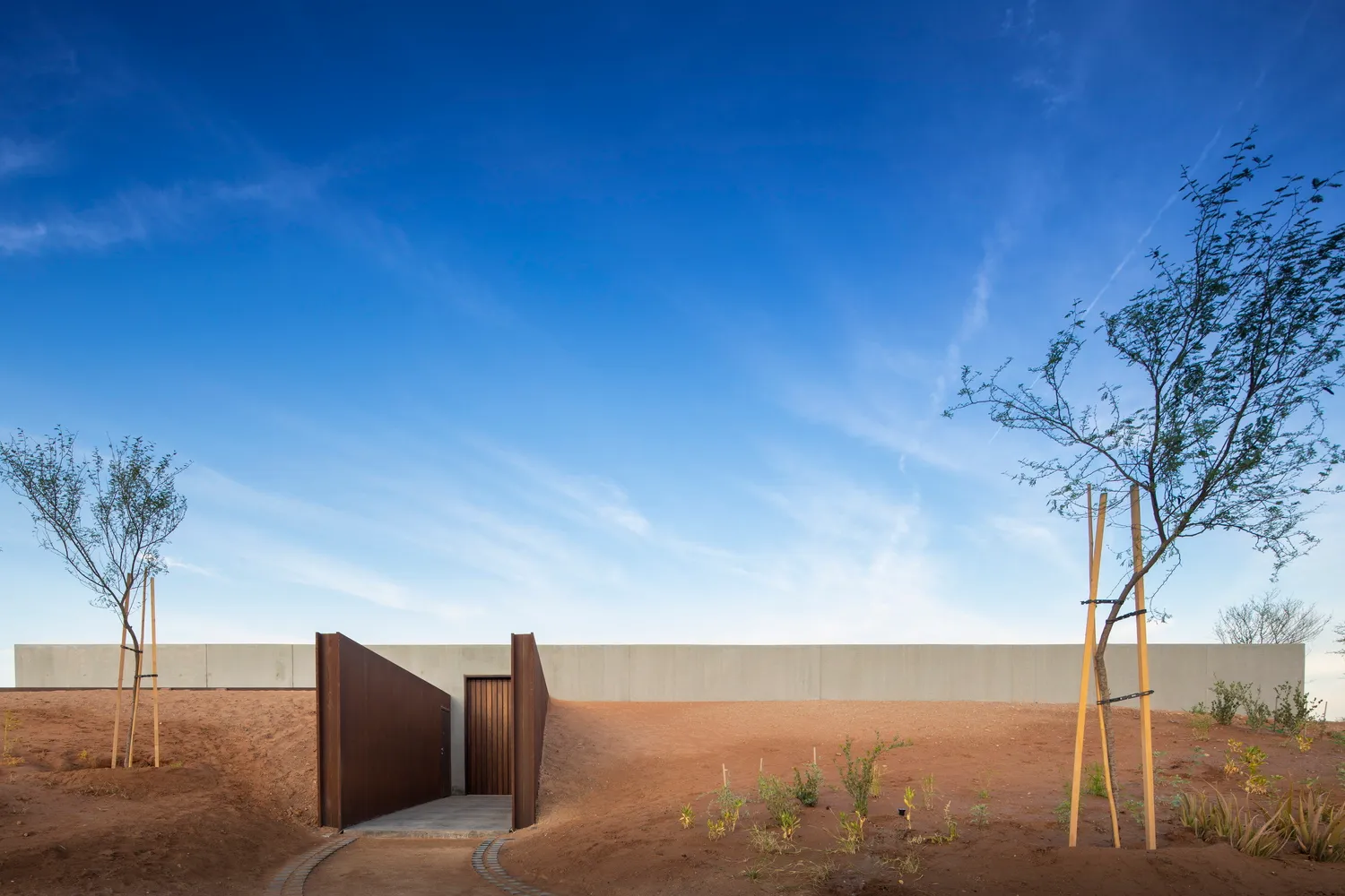A modern building exterior with a concrete facade viewed outdoors.