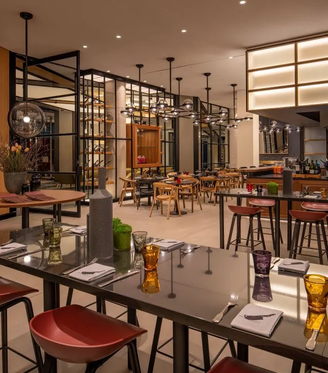 Modern industrial restaurant interior with metal, wood, and leather elements.