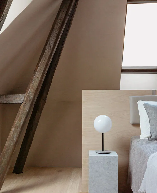 Minimalist bedroom featuring wooden beams and a sleek, modern design.