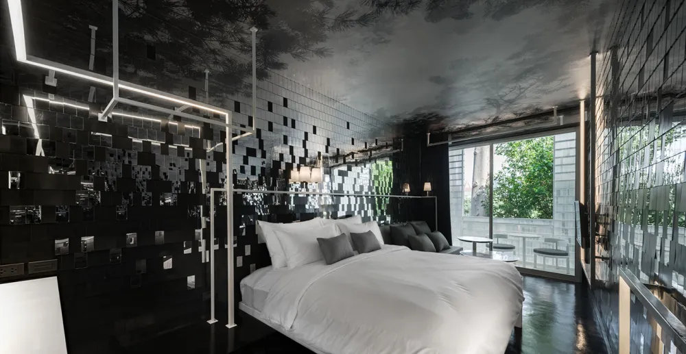 Modern bedroom featuring metallic tiles with black accents, white bedding, and large windows overlooking greenery.