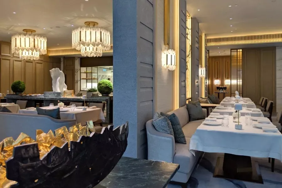 Modern restaurant interior with marble accents and elegant lighting.