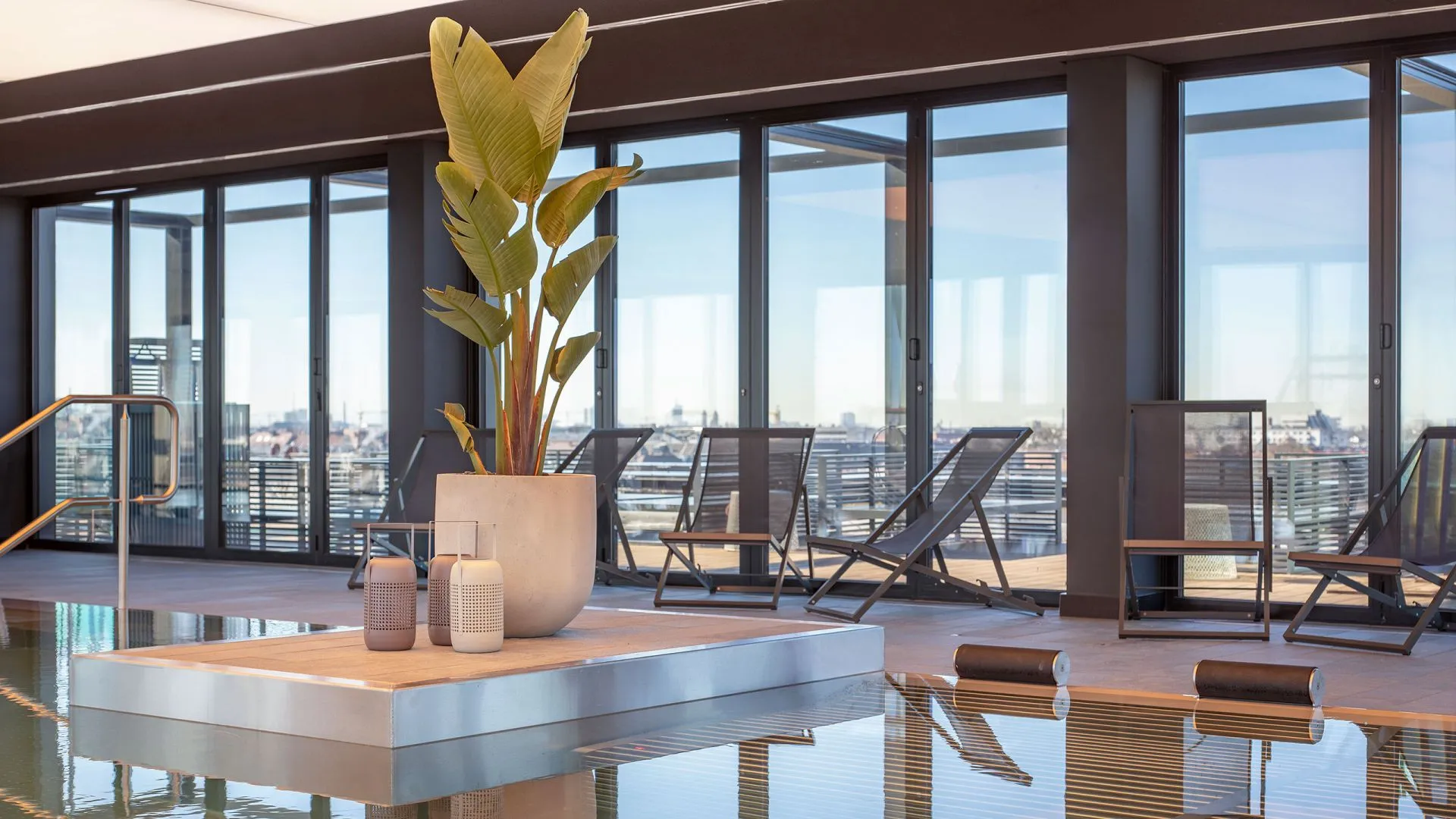 Modern interior space with concrete elements and lounge chairs.