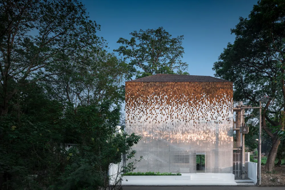 A modern house exterior featuring metallic mosaic shingles.
