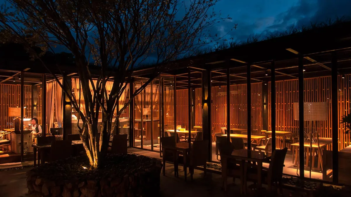 Modern restaurant interior featuring wooden elements and a warm, inviting atmosphere.