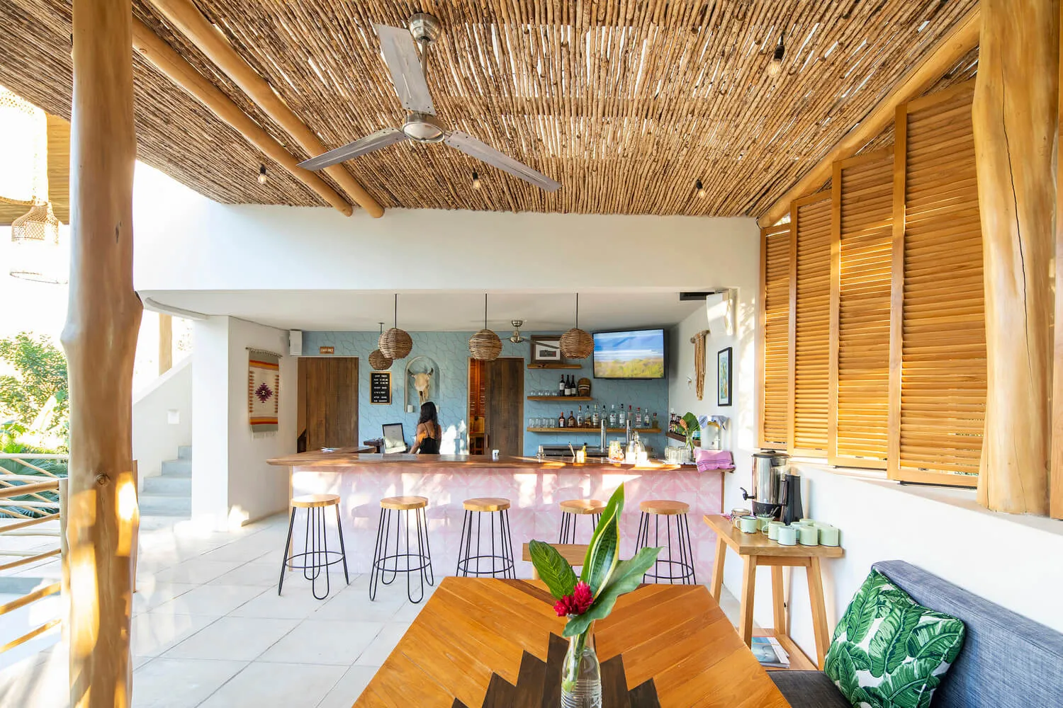 A spacious cafe bar with wooden elements and a bar counter.