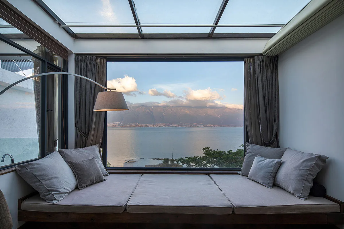 Comfy cushions with sea view, glass windows, and curtains
