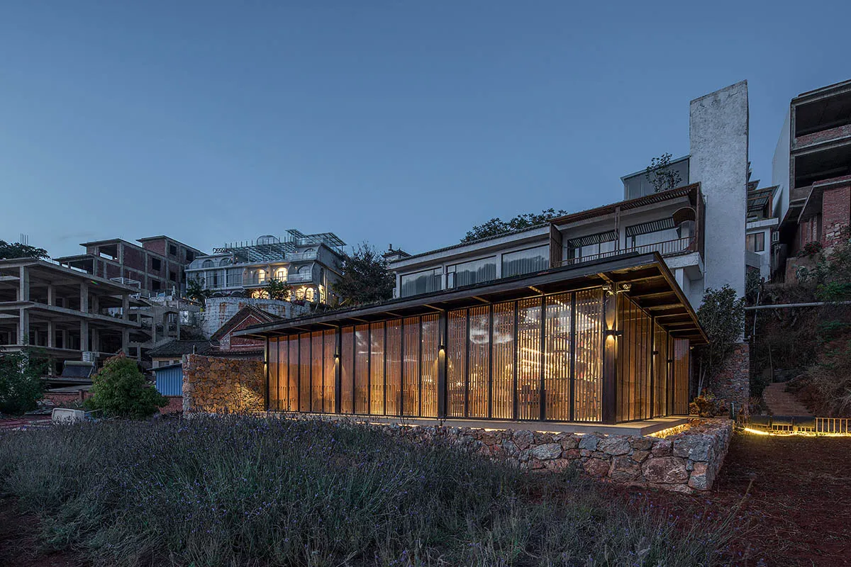 A modern building with large glass windows and wooden accents.