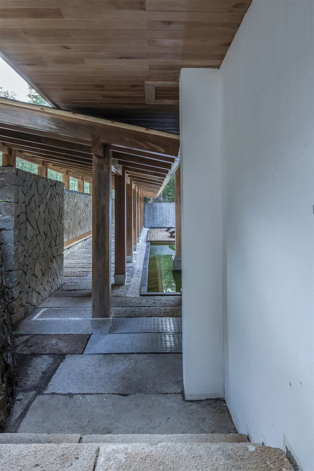 Modern architectural space featuring wood, concrete, and stone materials.