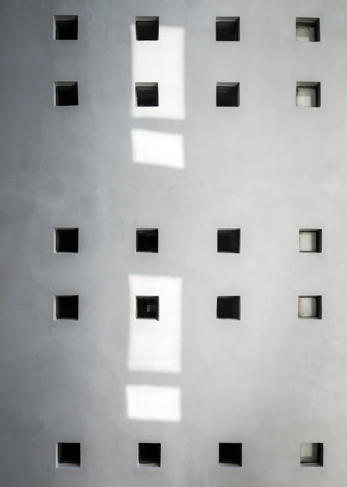 A minimalist block wall design made of concrete blocks.