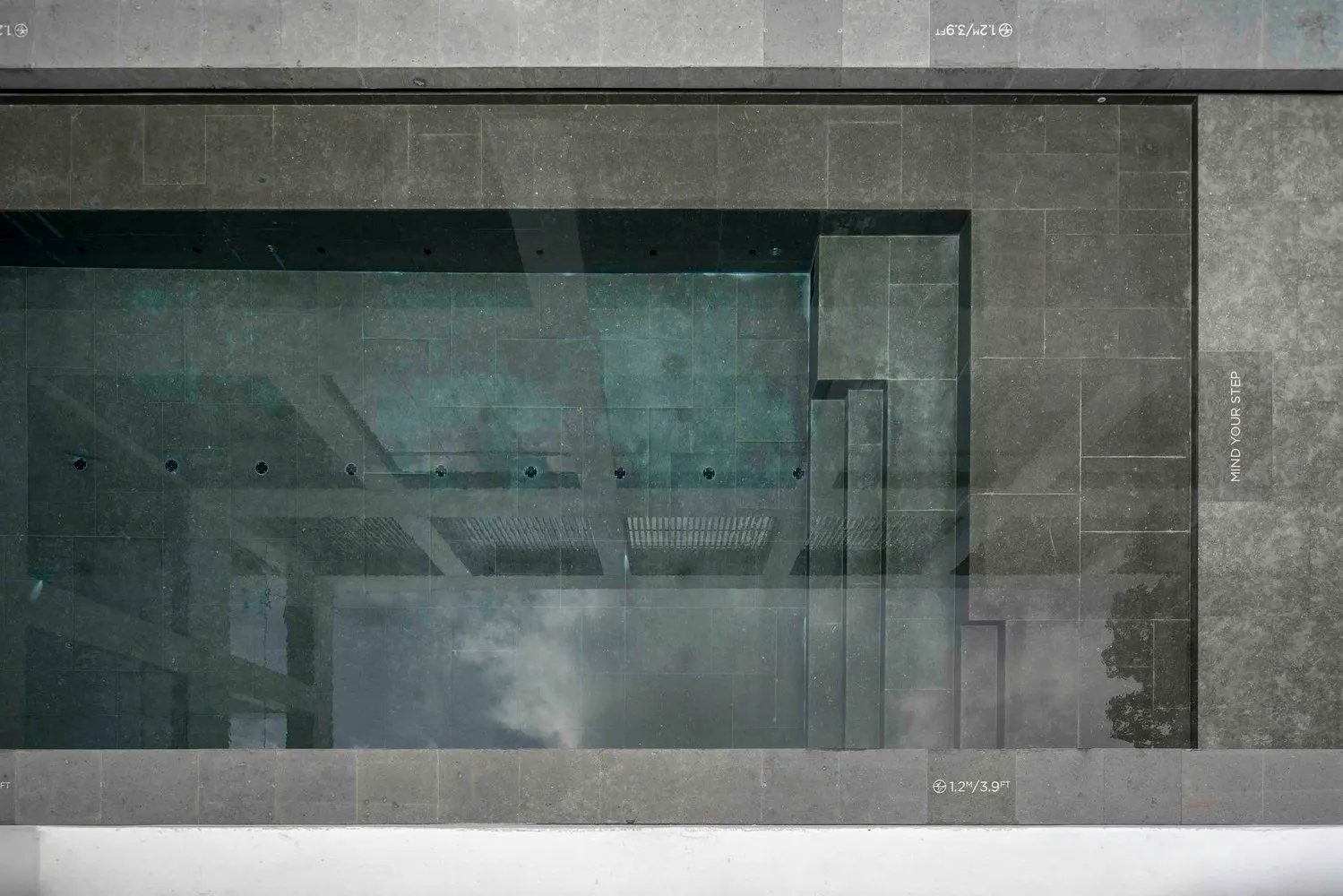Minimalist architectural design featuring concrete materials in a technical drawing format.