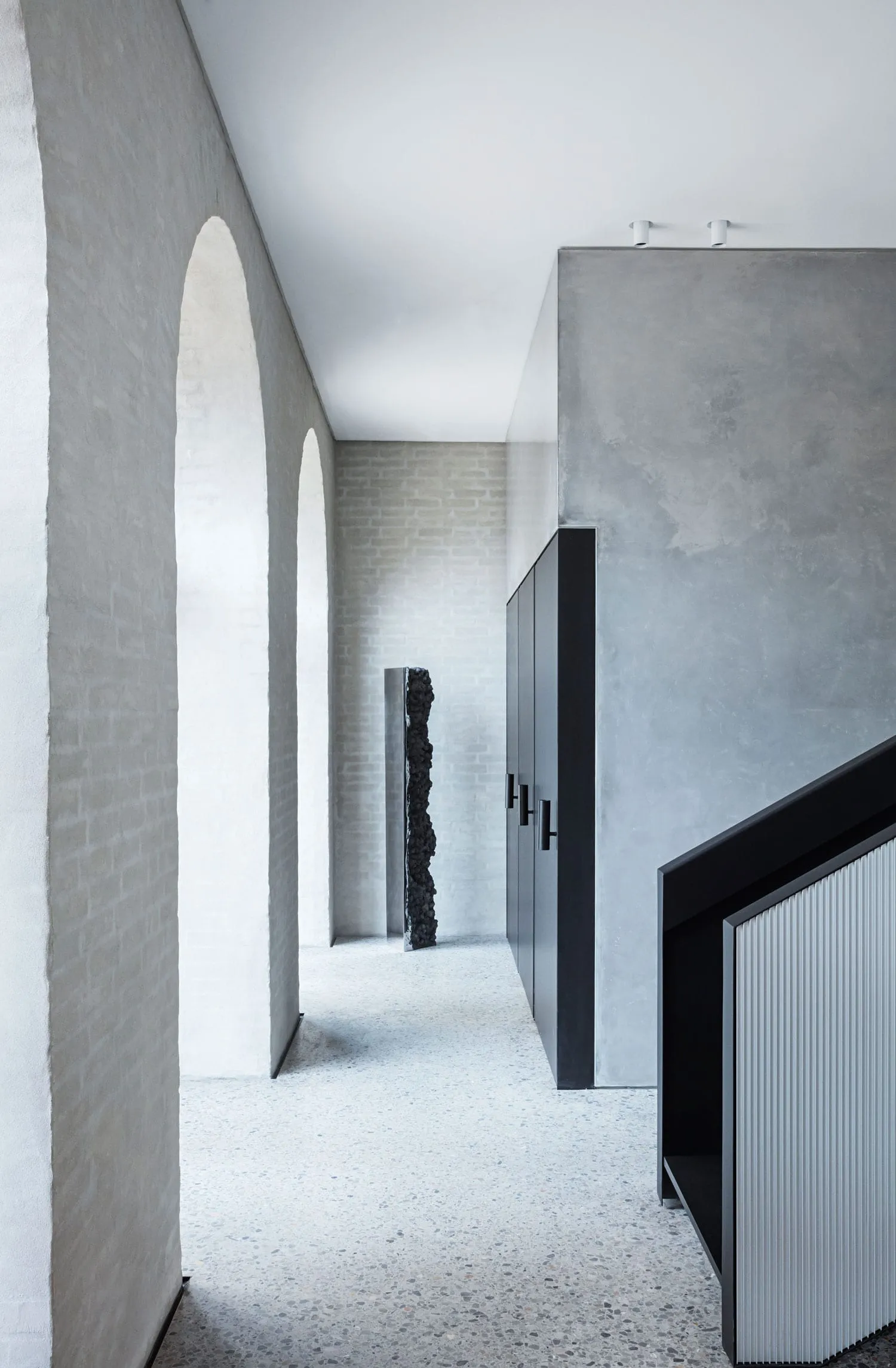 A modern interior space featuring concrete walls and floors.