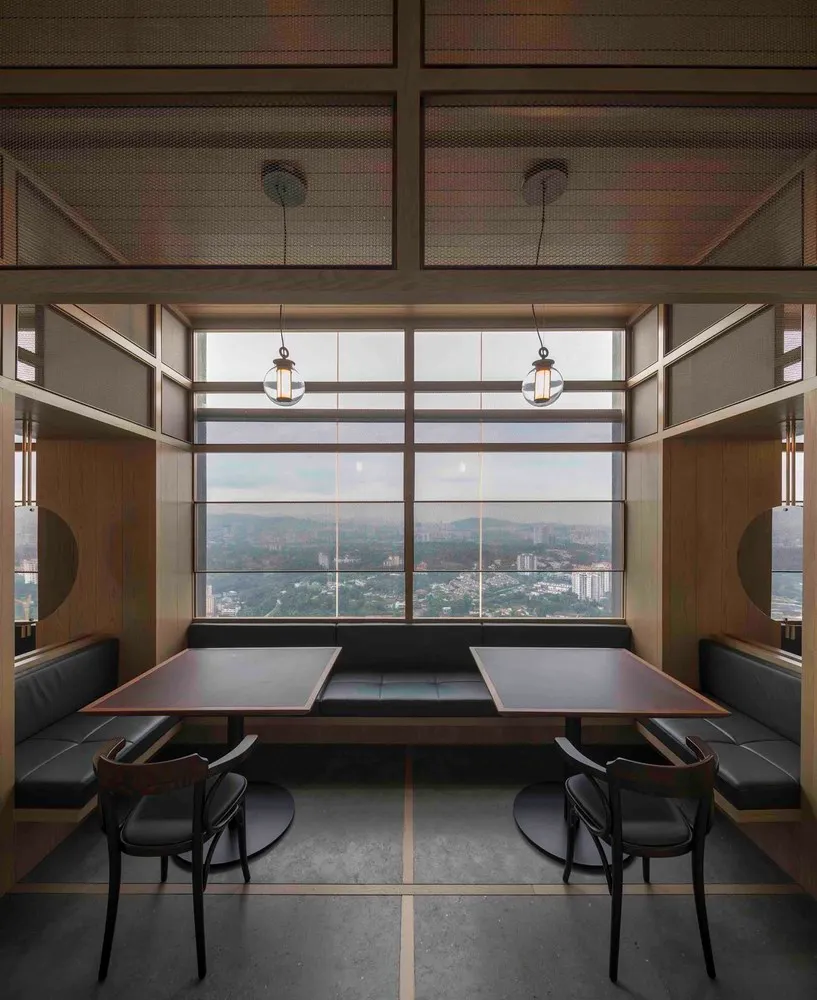 A minimalist restaurant dining room featuring wood and leather materials.