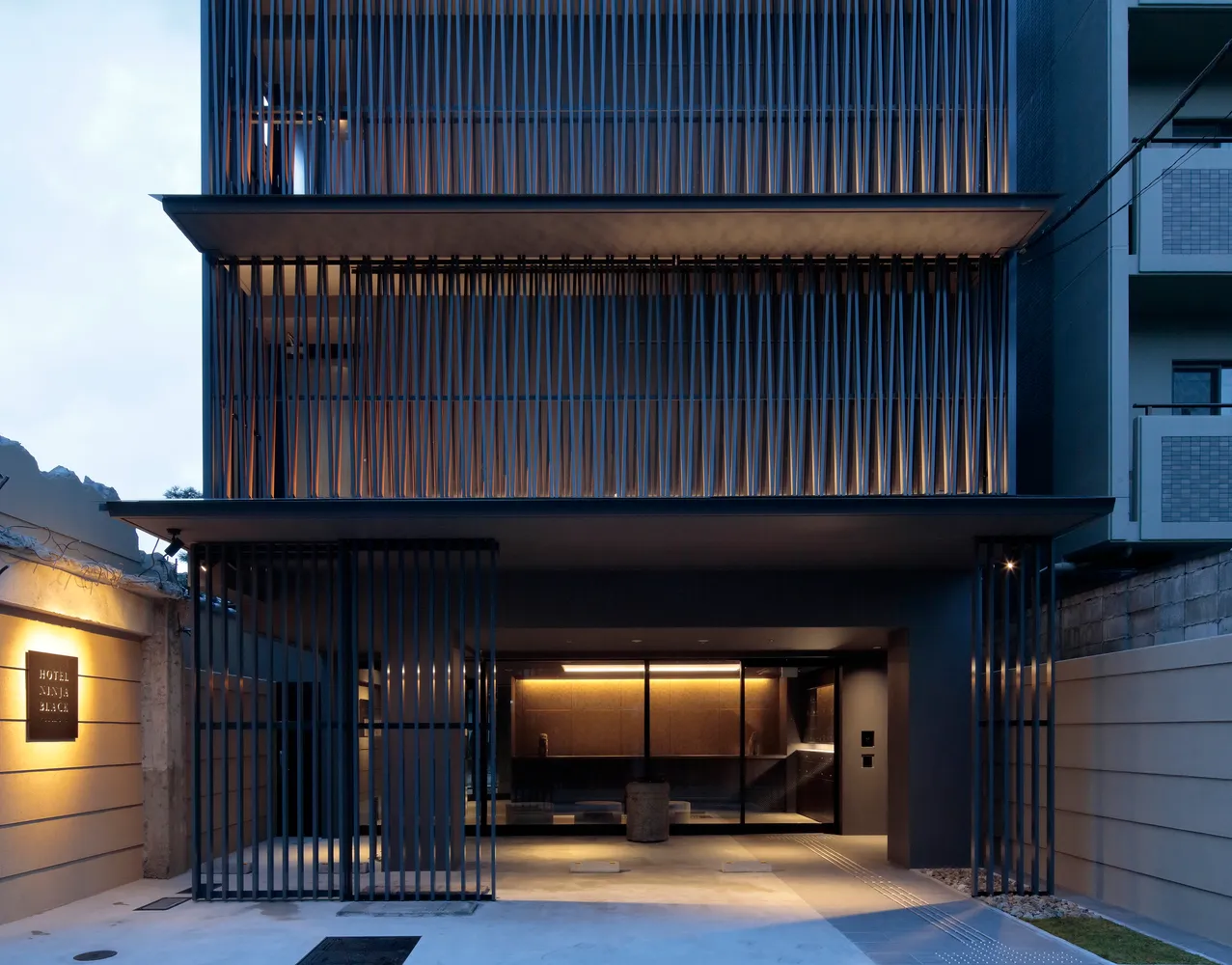 Modern hotel entrance featuring metal, glass, and stone materials