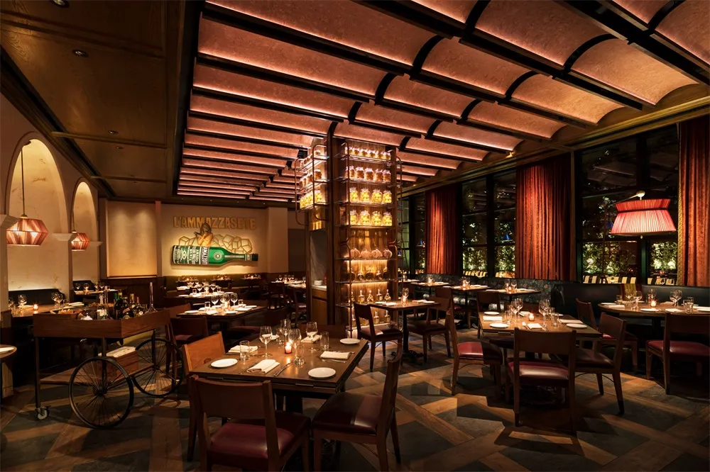 Well-lit restaurant interior featuring wood and copper accents, with tables set for dining and a bicycle as a decorative elem