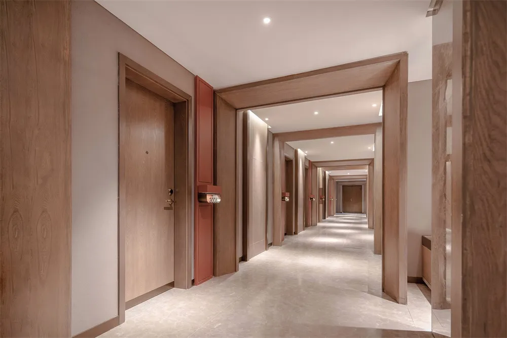 A modern hallway interior with wooden paneling and marble flooring.