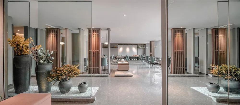 Modern lobby design featuring concrete and glass elements.