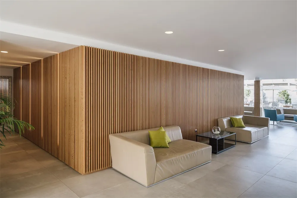 Modern commercial interior featuring minimalist design, wood-paneled walls, and contemporary furniture.