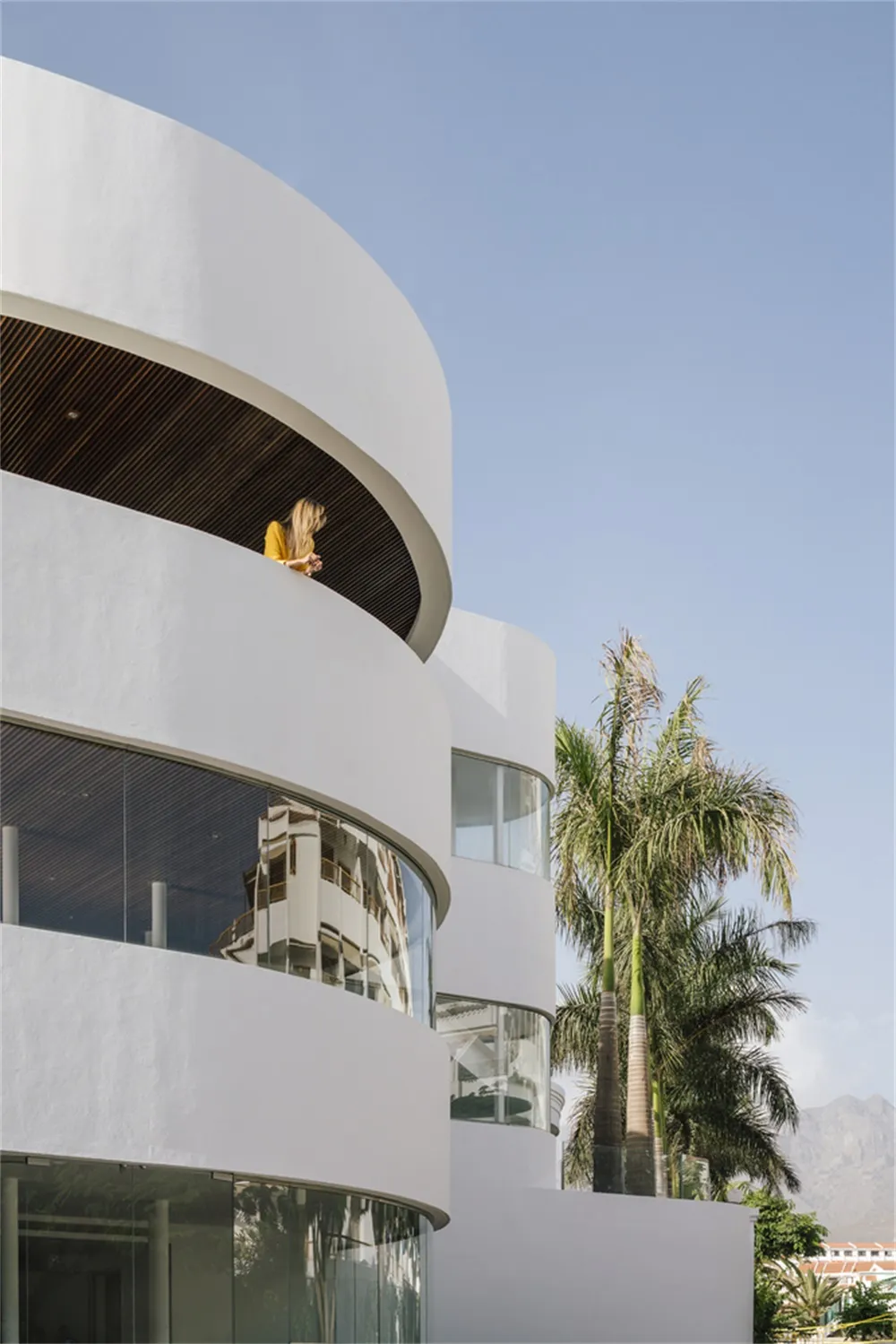 Modern residential exterior with white paint, glass, and wood accents