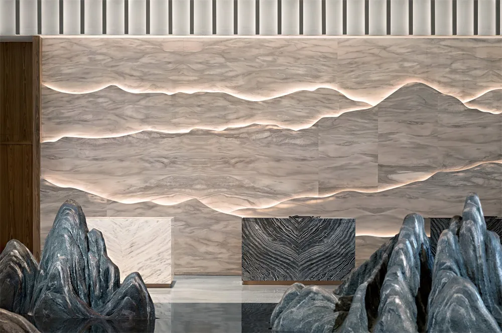 A modern lobby featuring marble, concrete, and metal materials.