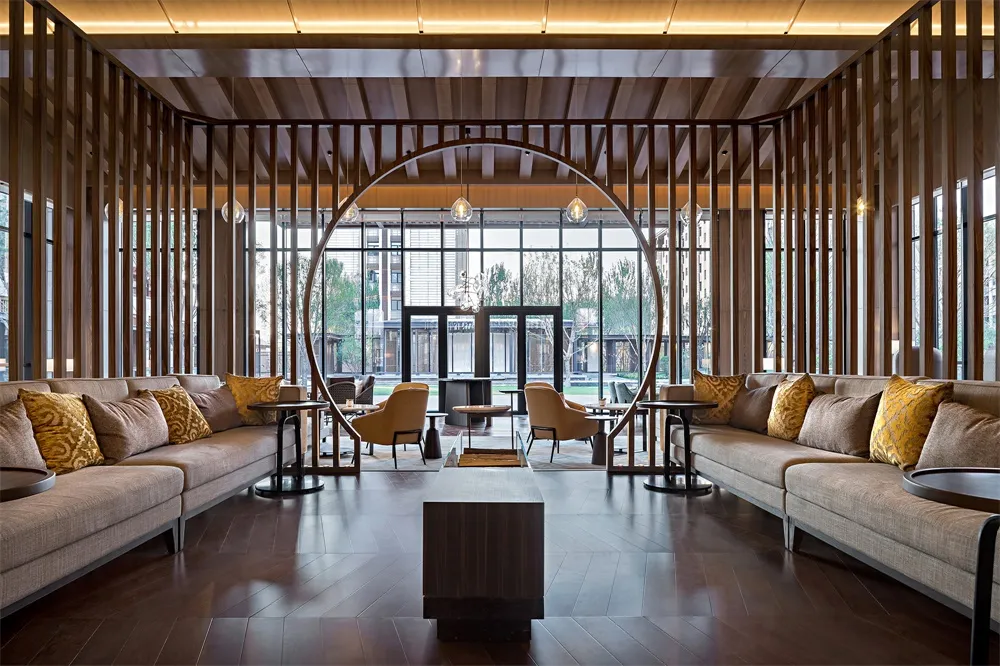 Modern, open-concept lobby featuring wooden accents and glass walls.