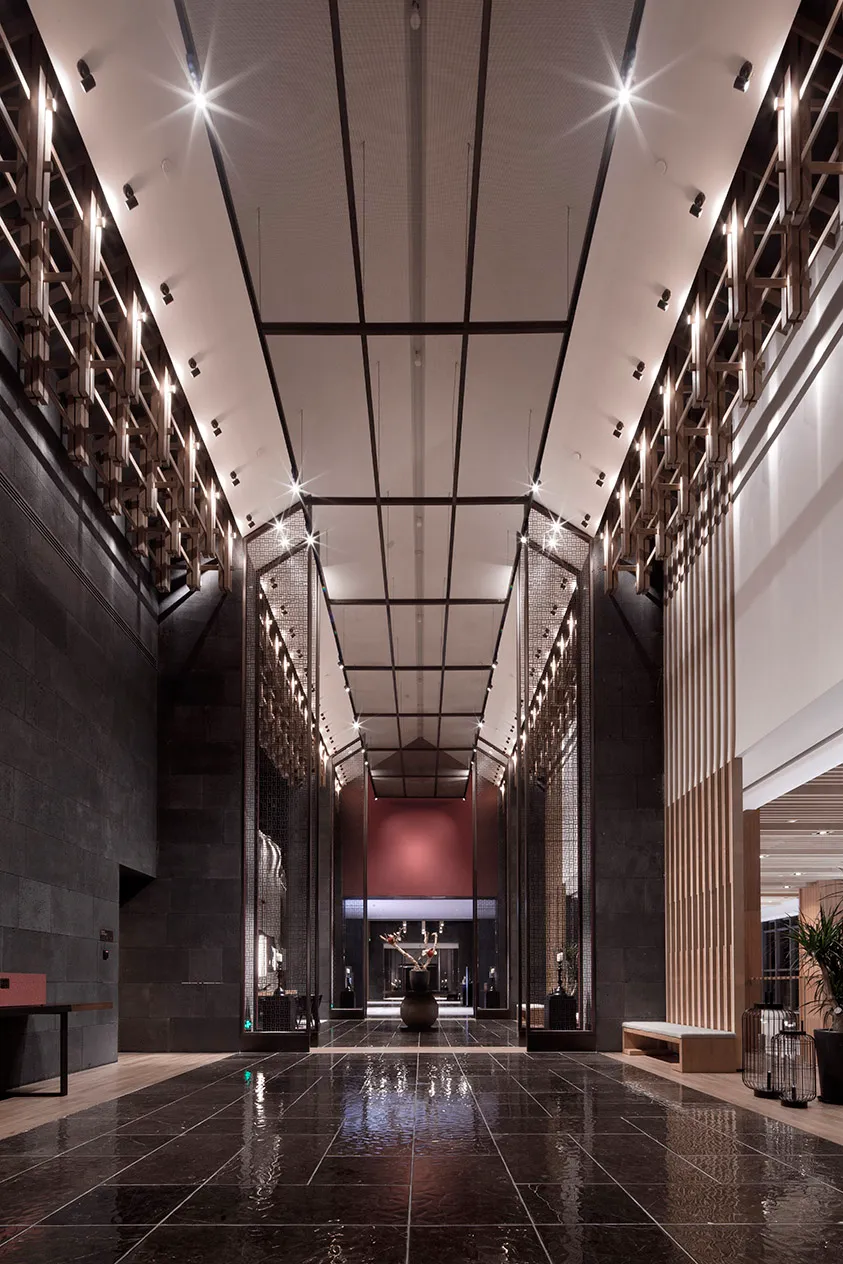 Modern hotel lobby interior with glass walls and concrete flooring