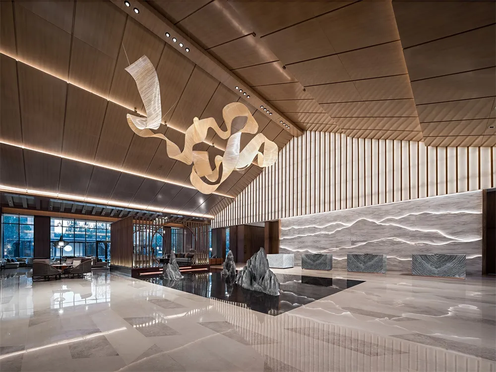 A luxurious, minimalist lobby featuring contemporary marble materials and sleek design elements.