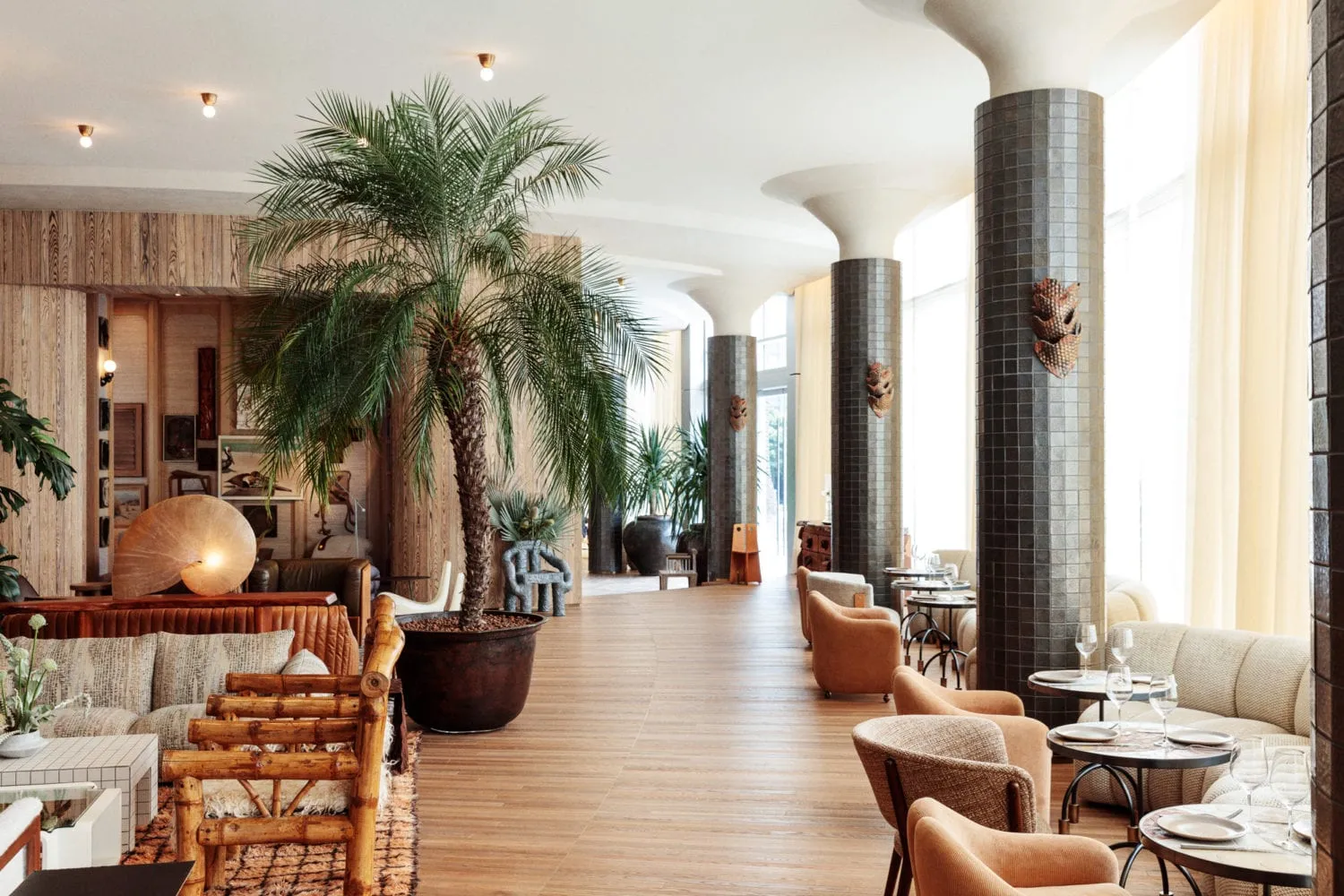A modern restaurant lounge with wooden furniture, ceramic tile accents, and upholstered seating.