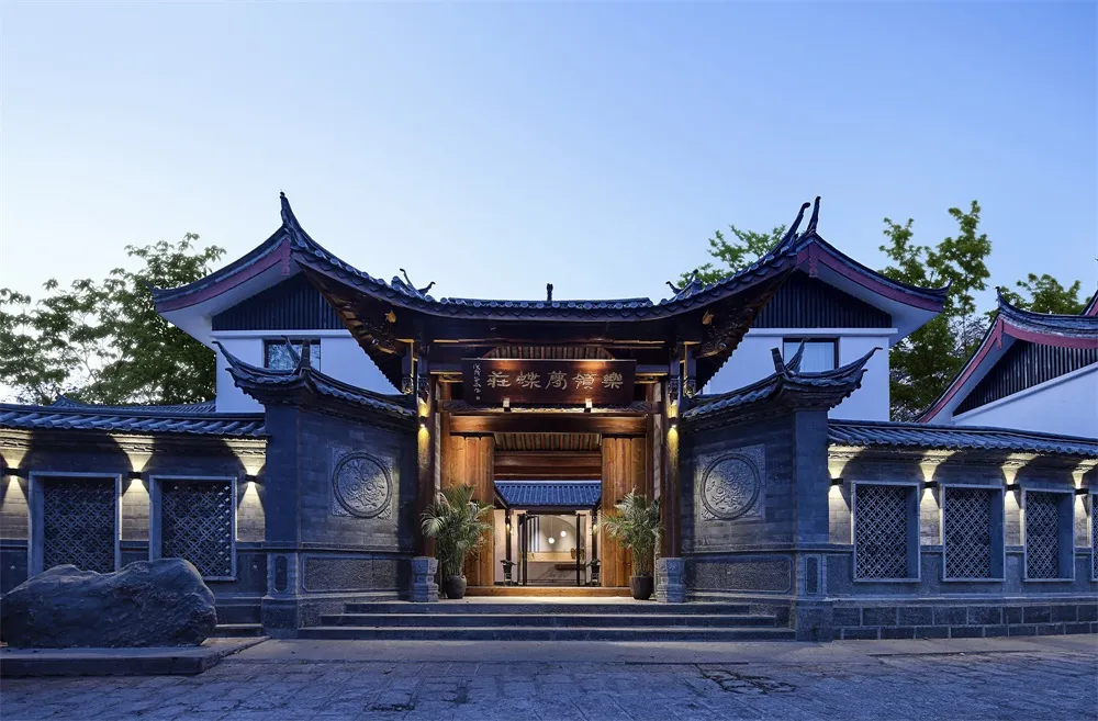 A traditional Chinese architectural structure with wooden beams, stone pillars, and clay tiles.