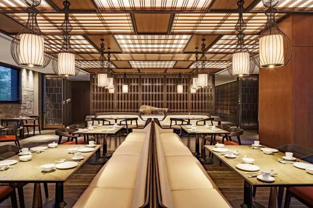 Modern restaurant interior featuring wooden and metallic elements.