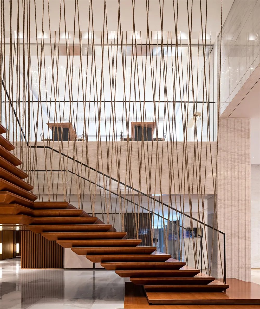 Modern staircase with decorative wooden steps and hanging ropes