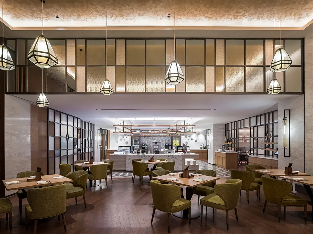 Dining and bar area of a modern restaurant with tables, chairs, and a service counter.