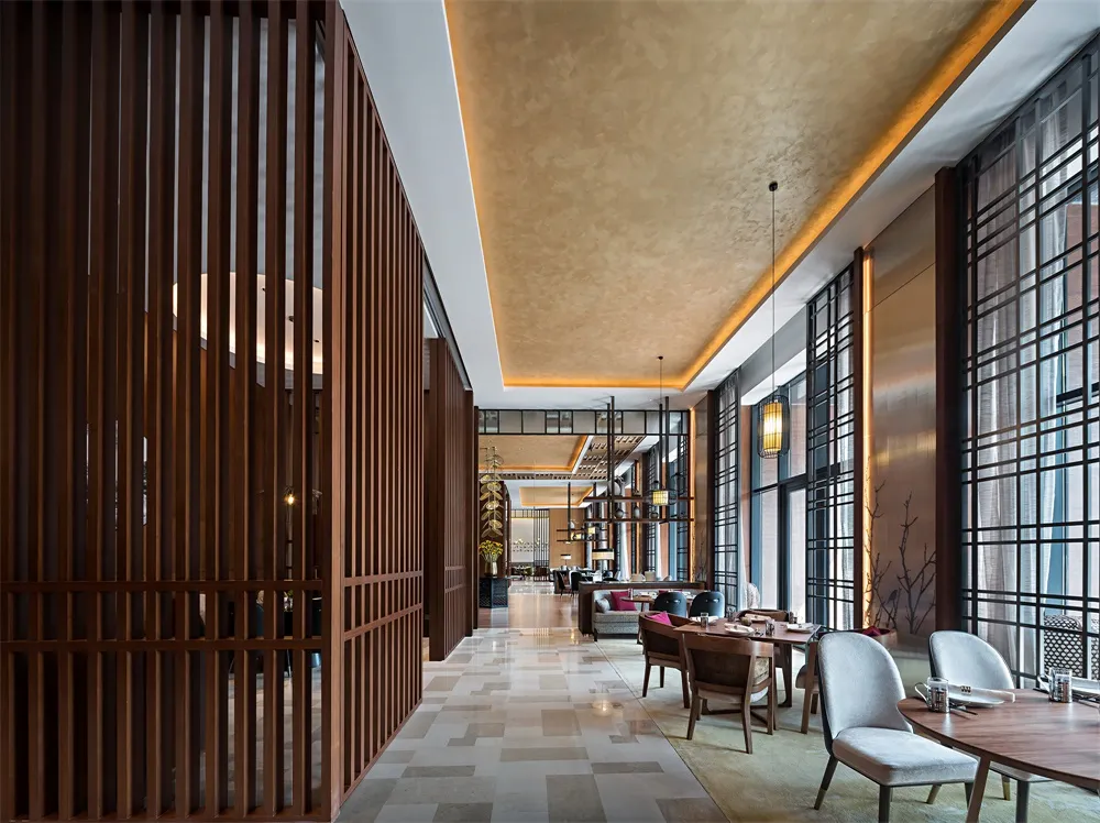 Modern restaurant interior featuring a combination of wooden slatted walls and stone-tiled floors.
