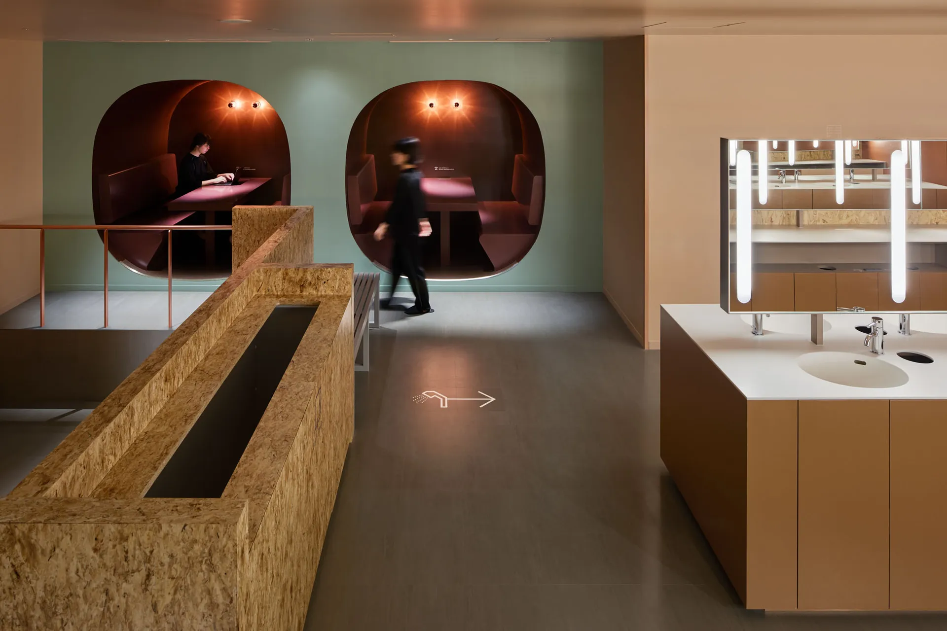 A modern industrial office space with concrete, wood, and glass elements.