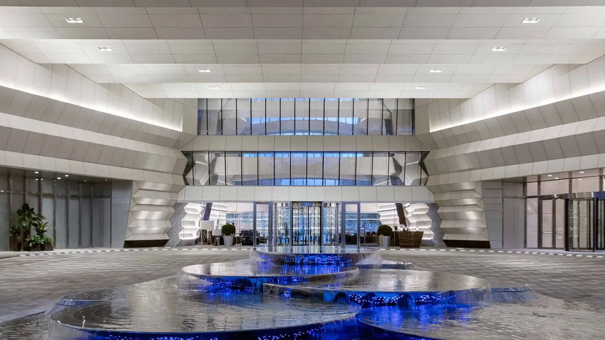 A modern office lobby featuring glass and stone materials.