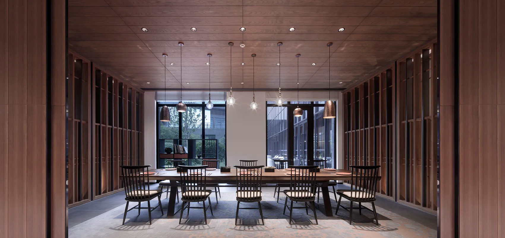 A modern restaurant interior with wooden floors, glass windows, and metal accents.