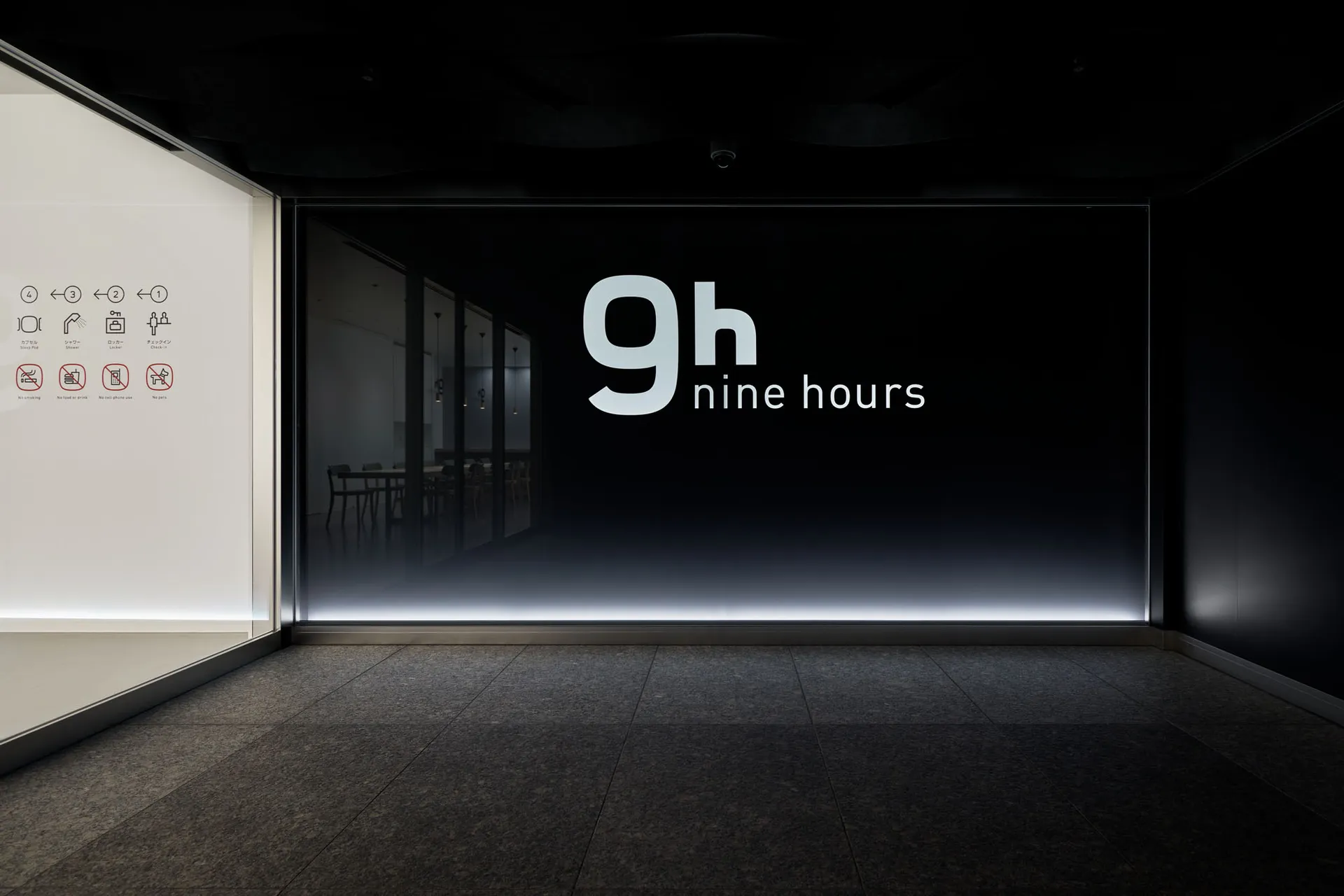 A minimalist storefront with a glass facade.