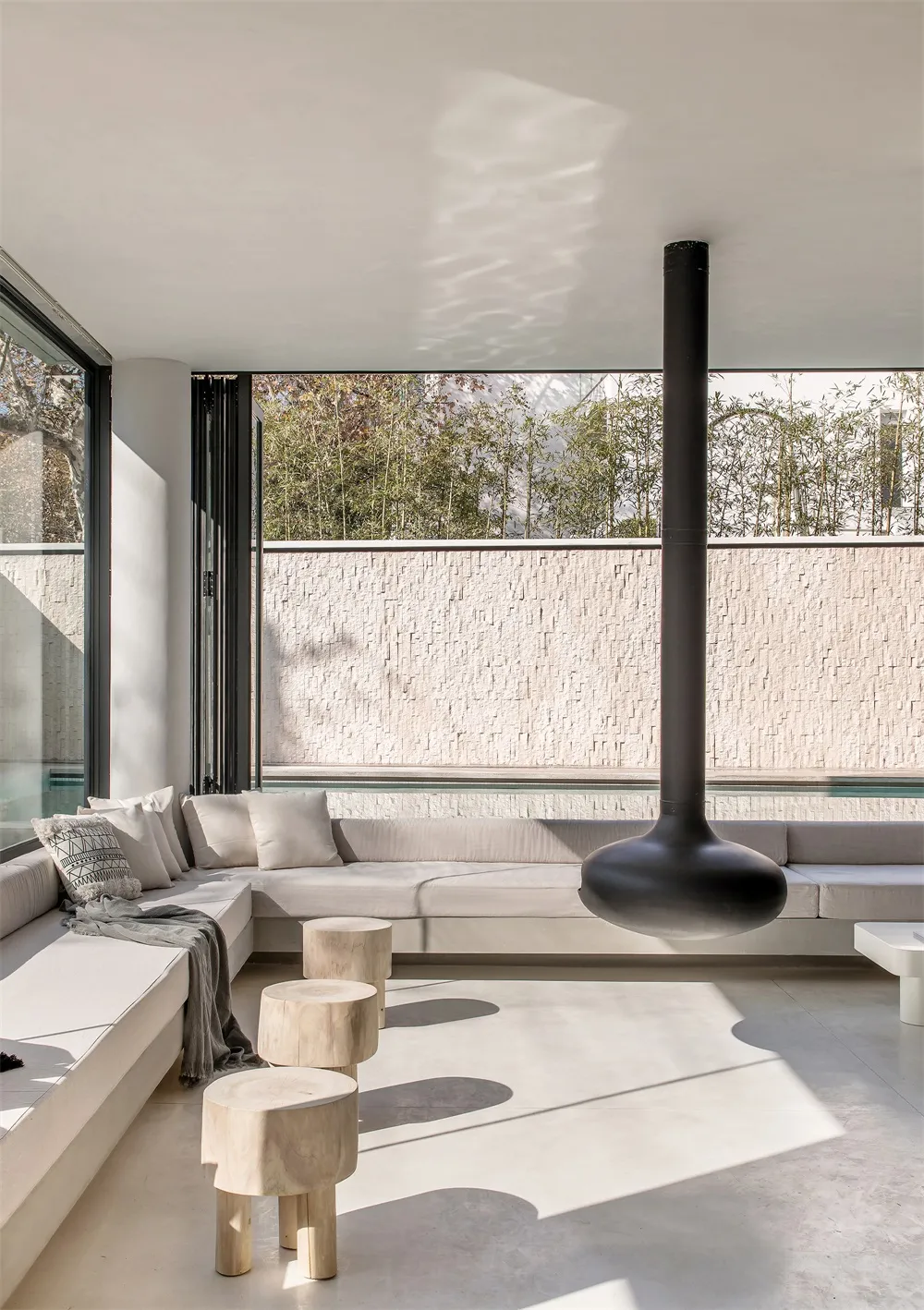 Modern living room with concrete furniture and minimalist design.