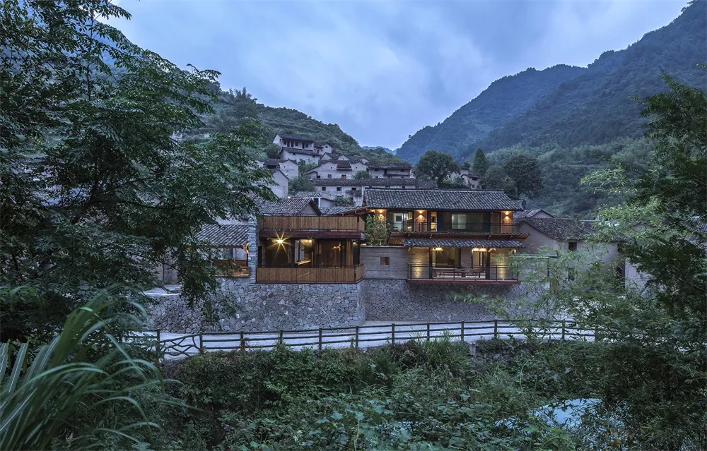 Stone and wood residential house in a village setting.