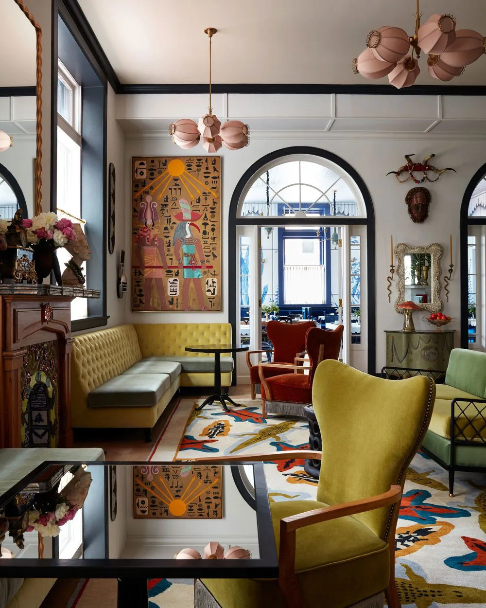 A bohemian-style living room with vibrant textiles, eclectic furniture, and intricate design elements.