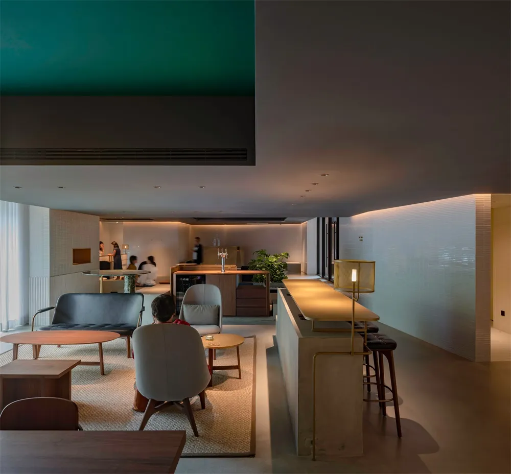 A minimalist residential space with concrete walls and wooden furniture.