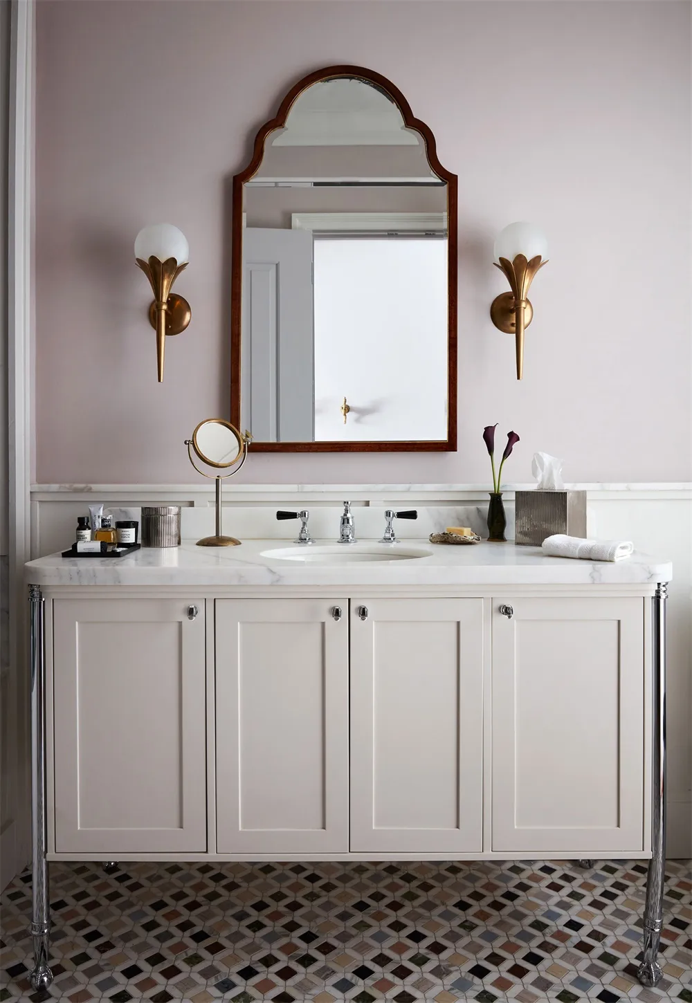 A modern bathroom with a marble countertop, concrete cabinets, and a sink cabinet space.