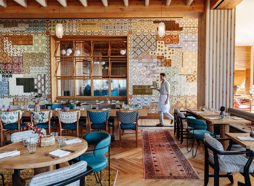Modern restaurant interior with patterned tiles and wooden elements.