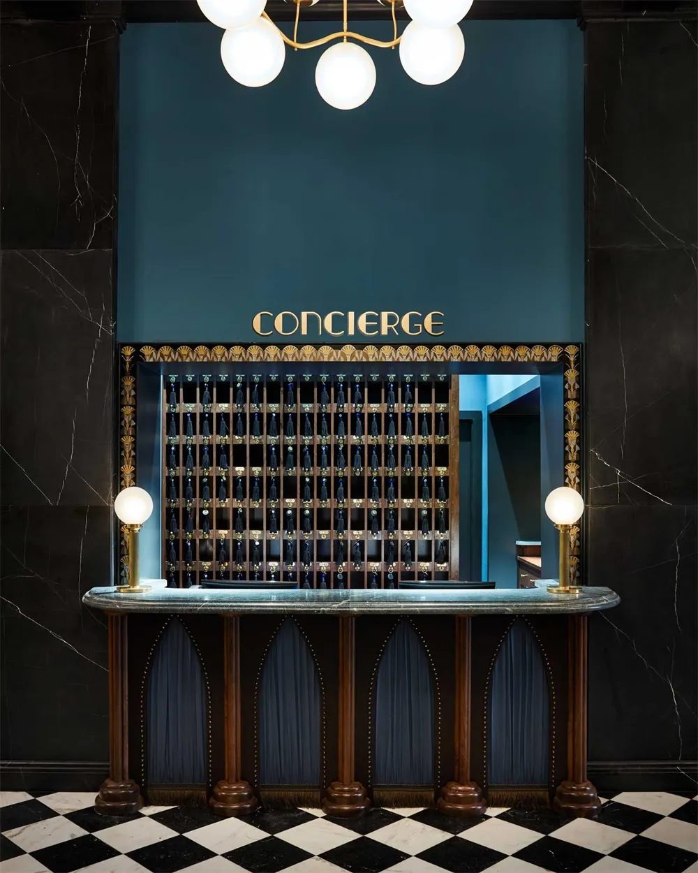 A luxurious hotel concierge desk with a marble countertop and a sign reading 'CONCIERGE'.
