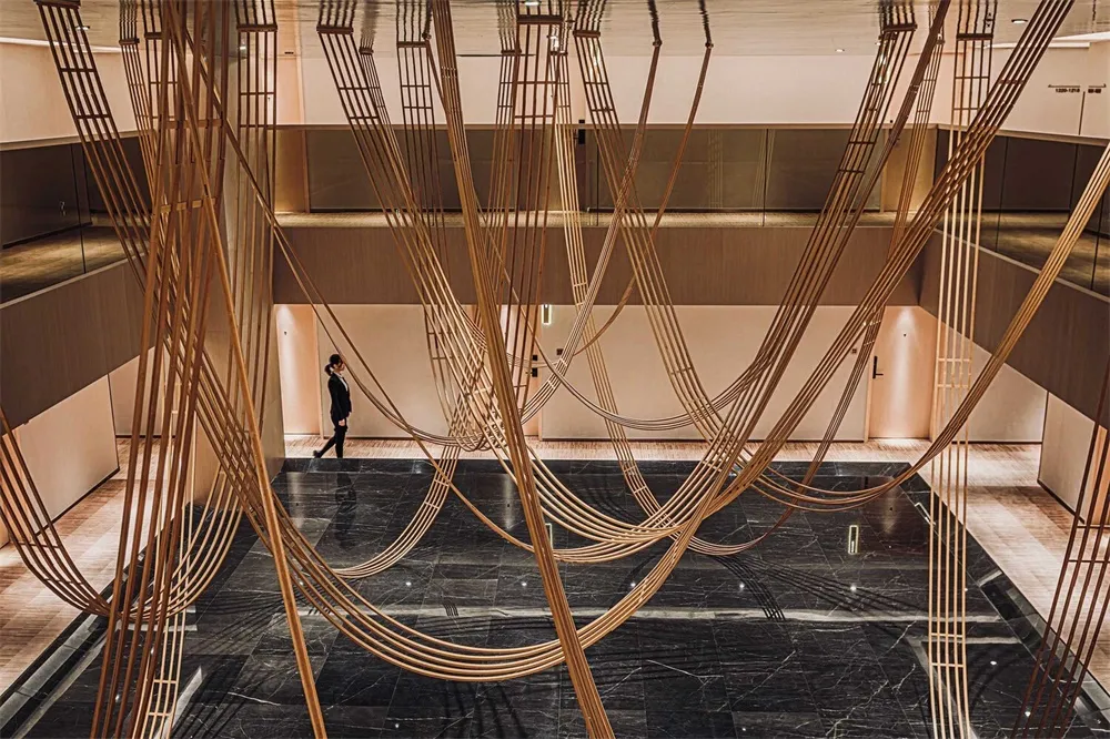 A modern lobby with a sophisticated design featuring marble and wooden elements.