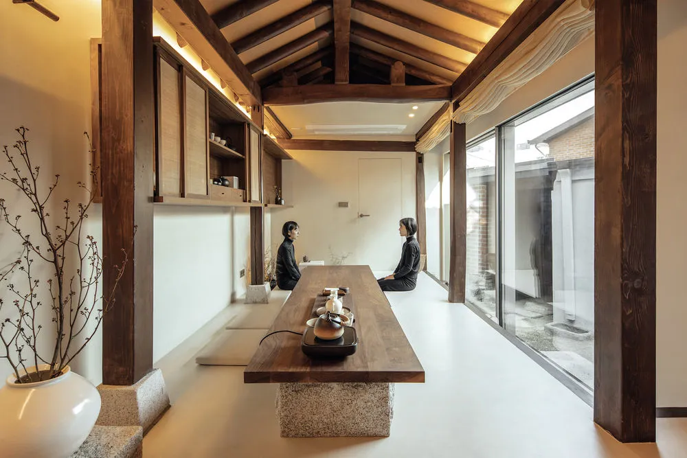 A minimalist coffee shop featuring a wooden counter and floor.