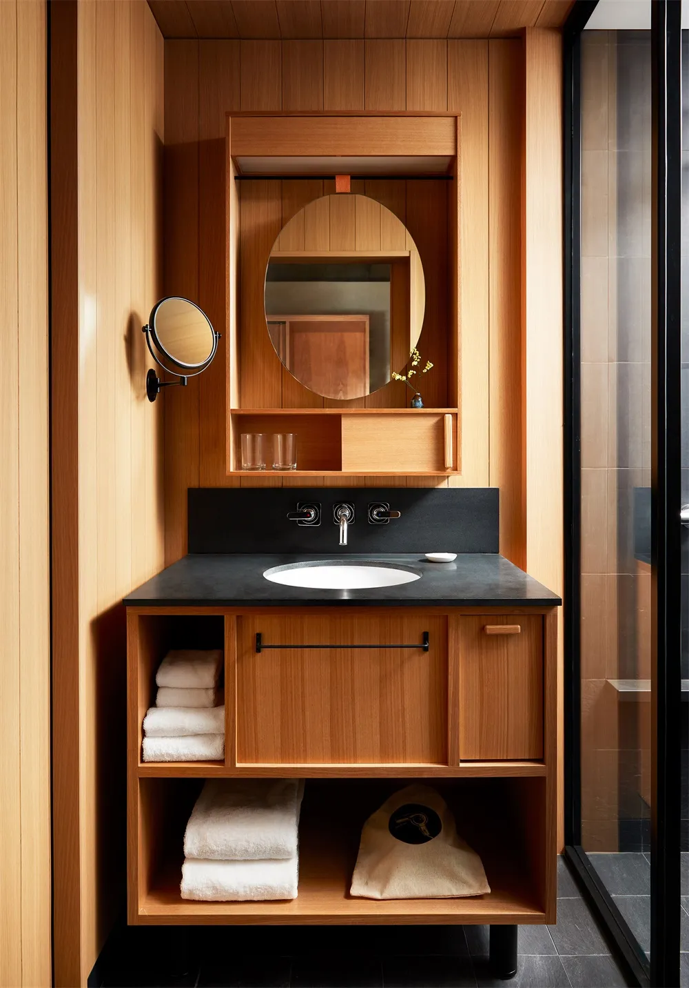 Modern bathroom featuring wooden vanity and porcelain sink