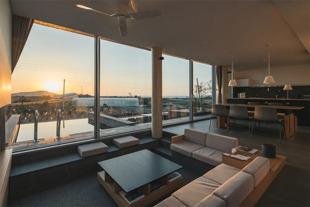 Modern residential living room featuring concrete and glass materials.